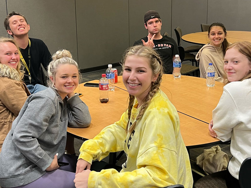 SDAP students around a table smiling for picture